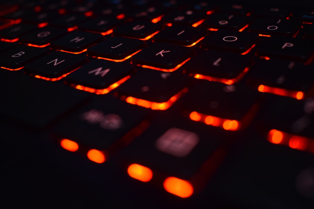 a close up of a keyboard with red lights