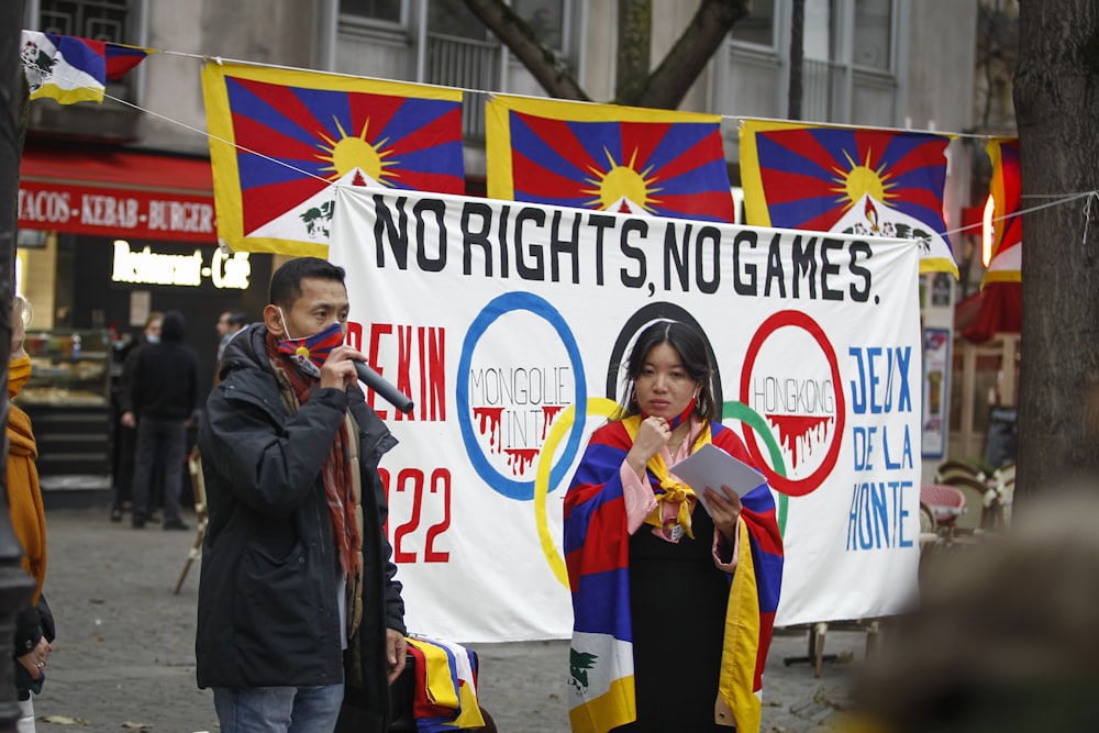 a woman standing next to a man on a street