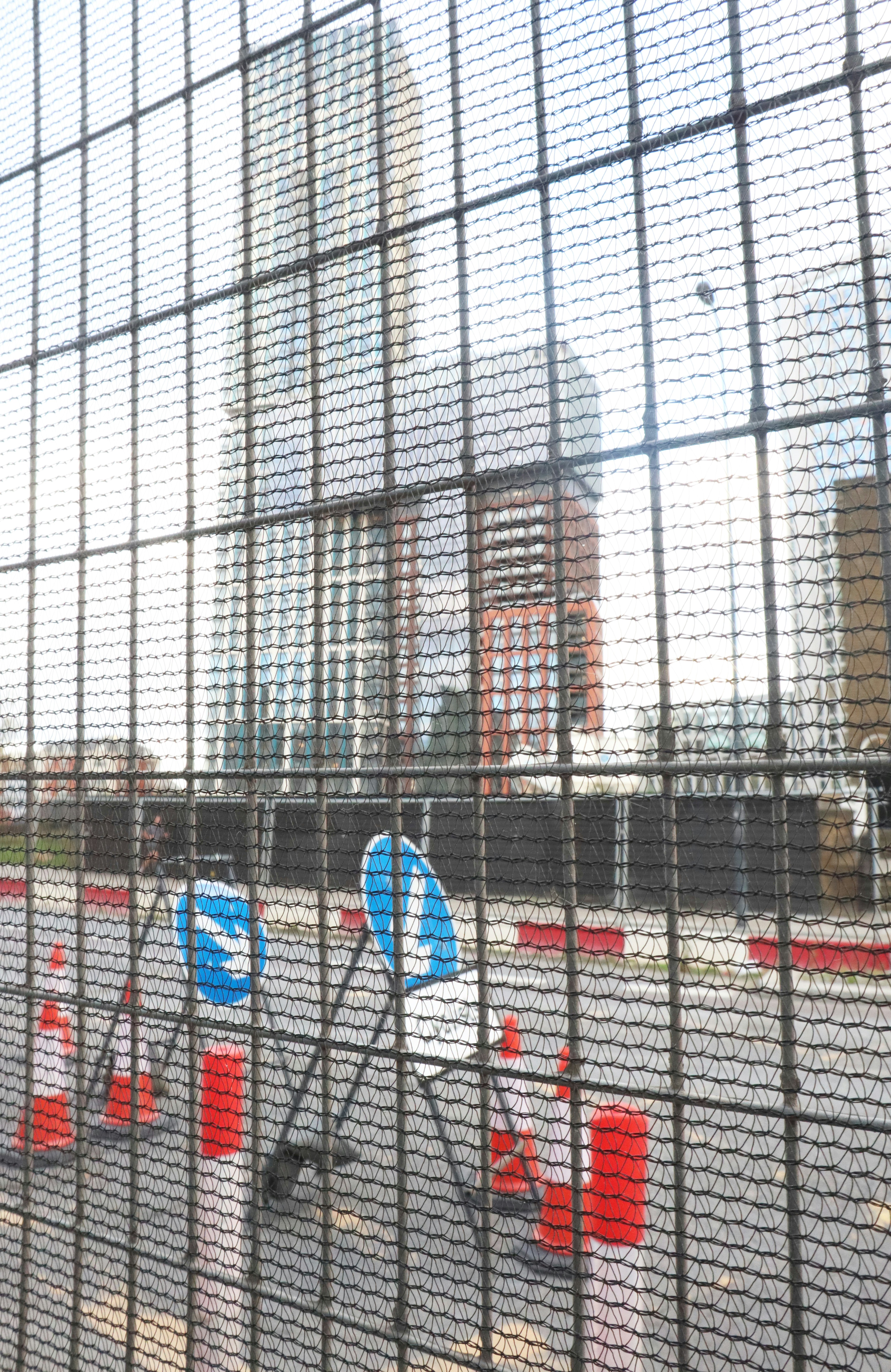 a view of a city through a fence