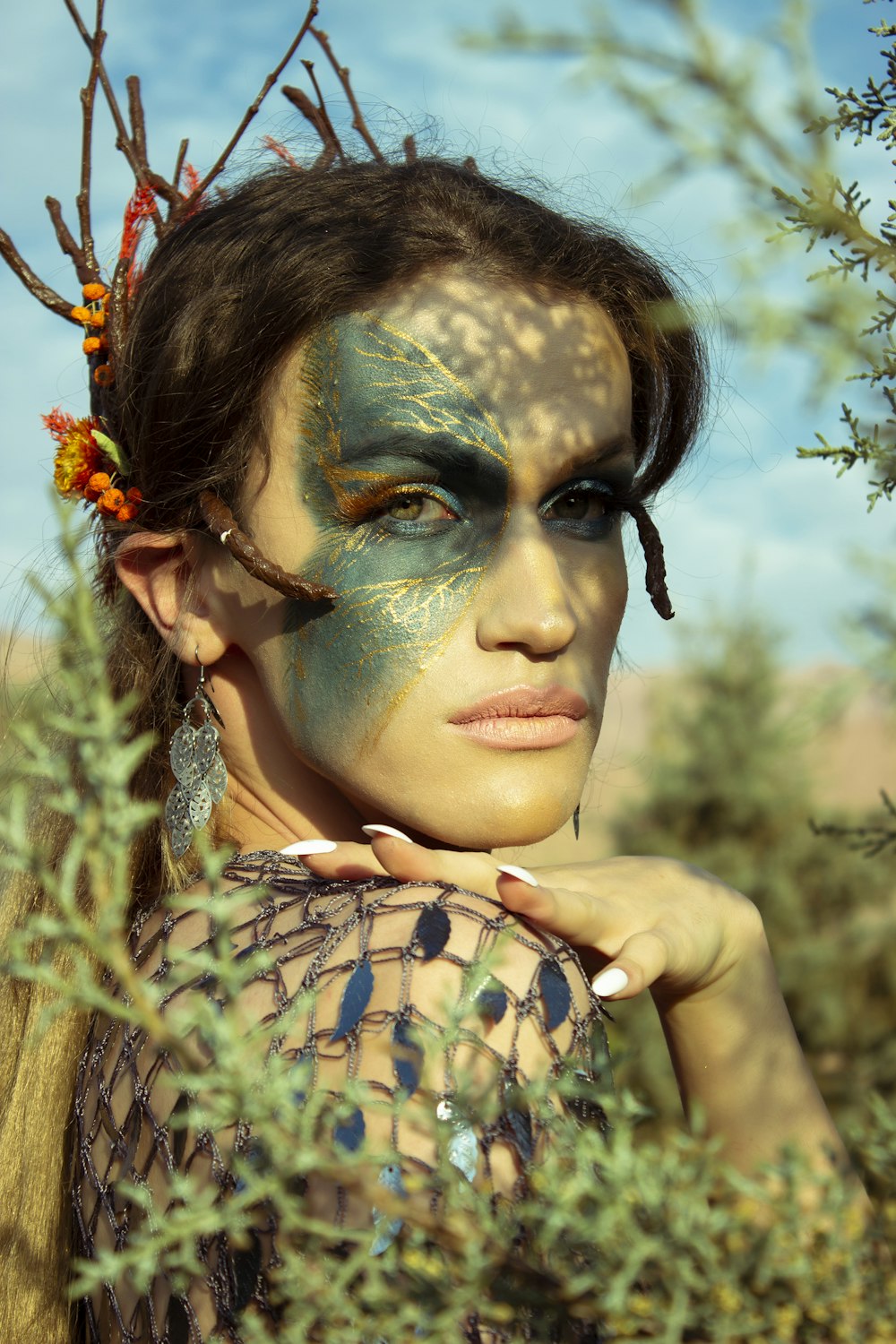 a woman with painted face and body in a field