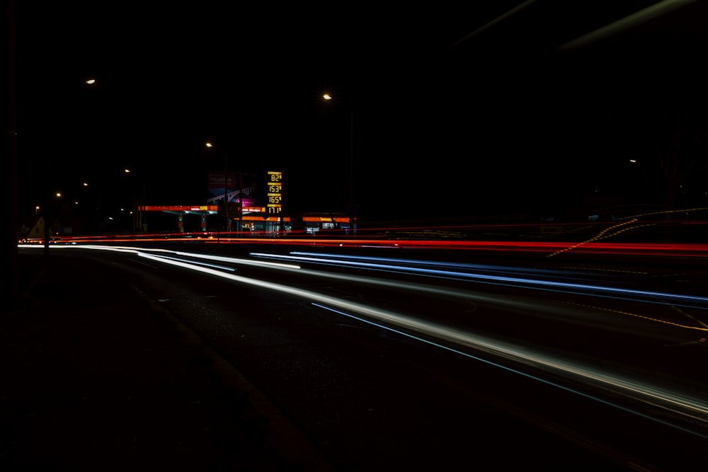 a long exposure photo of a city street at night