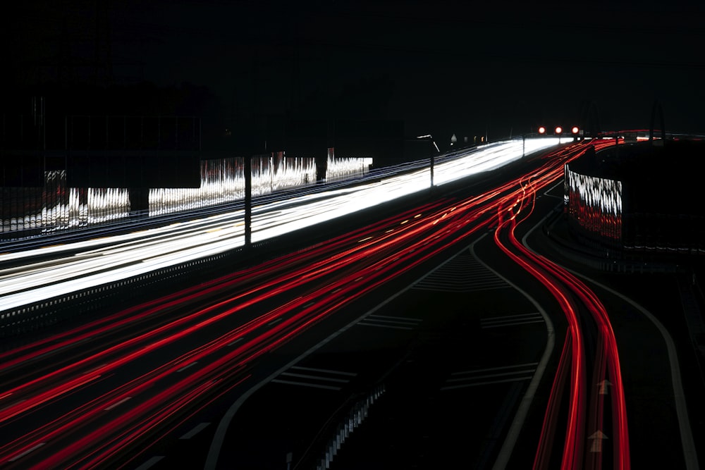 a long exposure photo of a highway at night