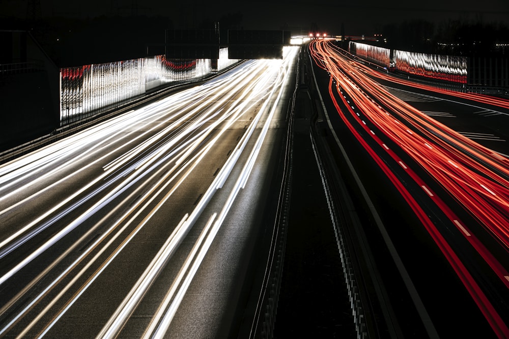 a long exposure photo of a highway at night