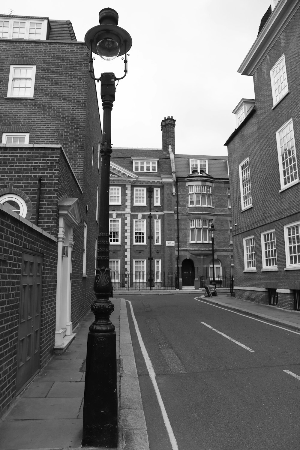 a black and white photo of a street light