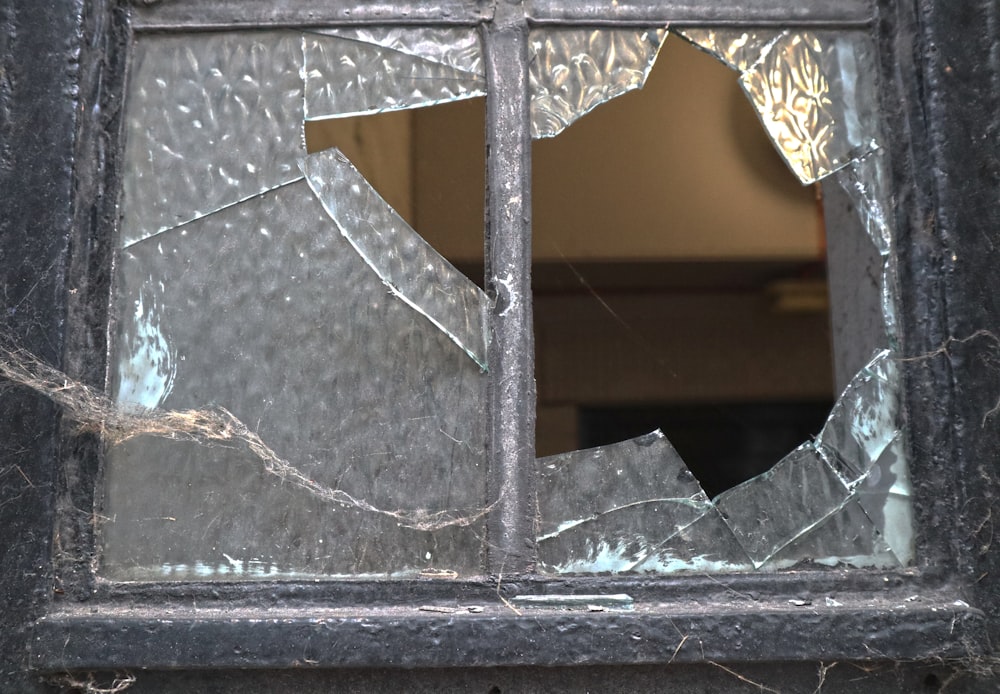 a broken glass window with a crack in it