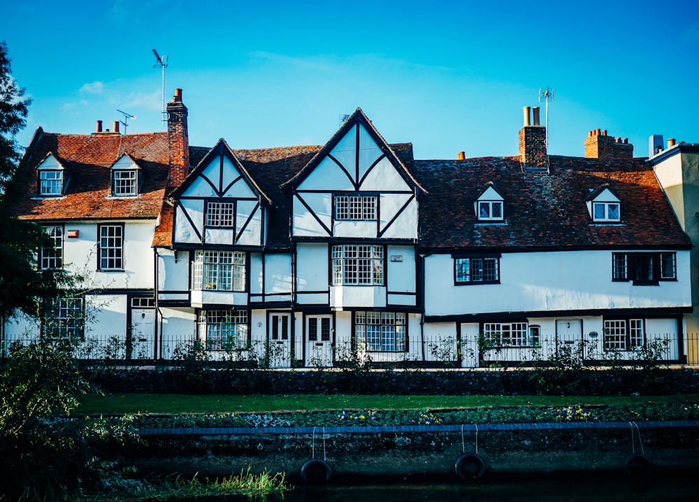 a row of white houses with brown roofs