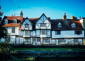 a row of white houses with brown roofs
