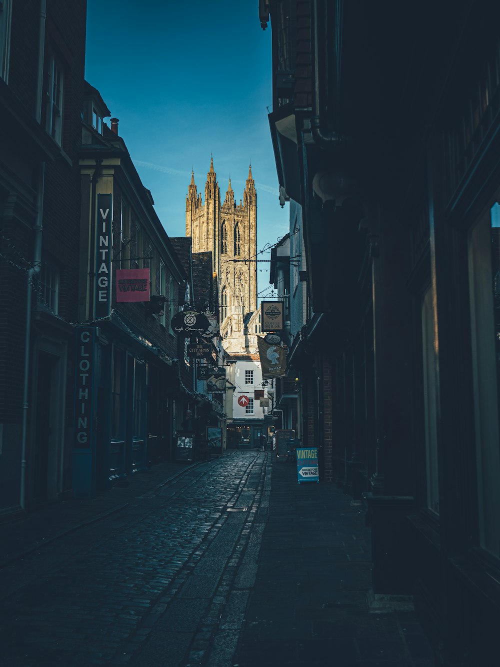 a city street with a church steeple in the background