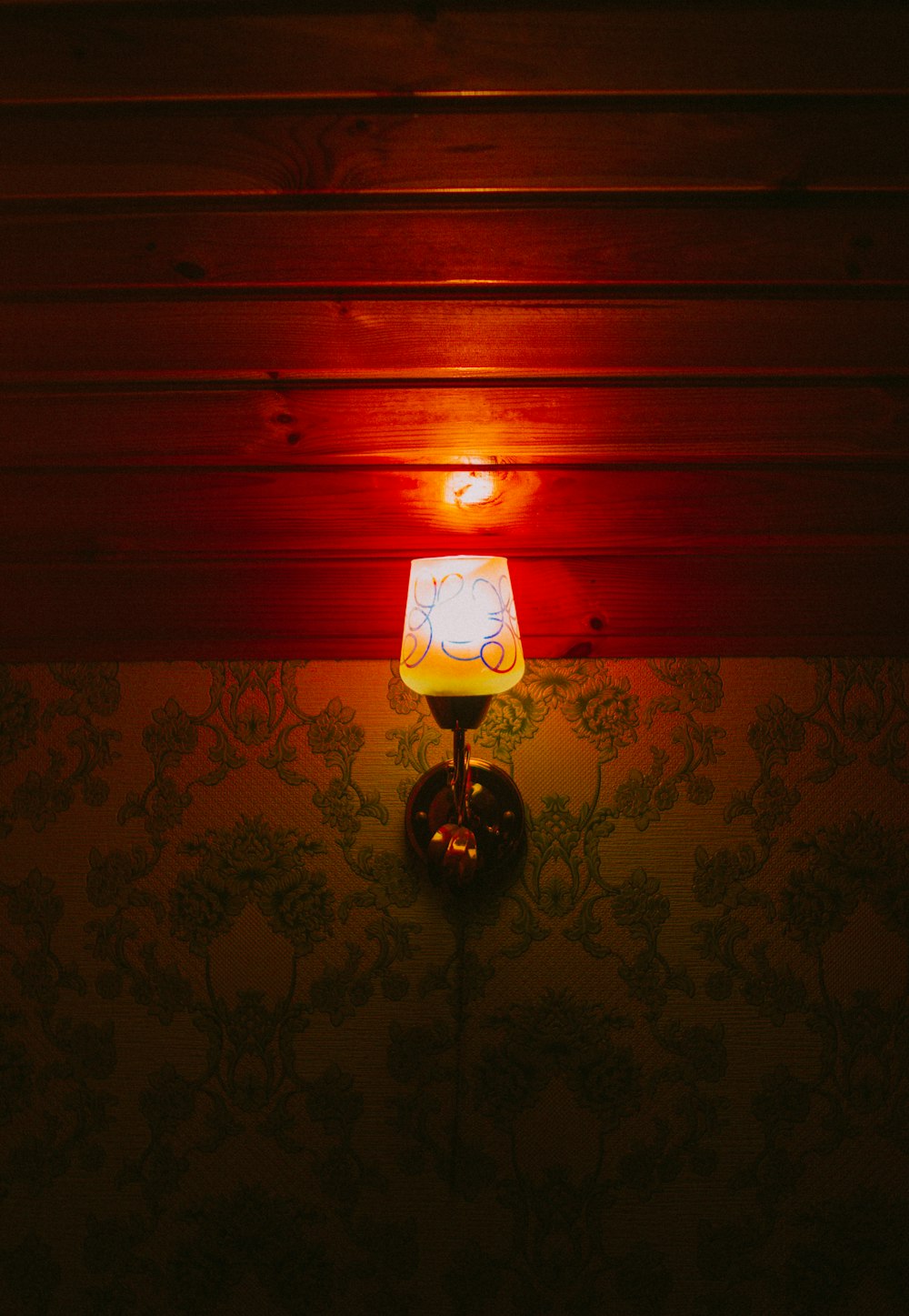 a lamp that is on a wall in a room