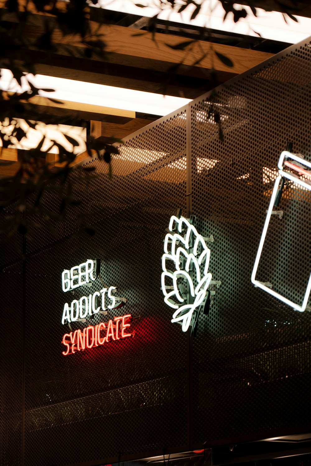 three neon signs on the side of a building