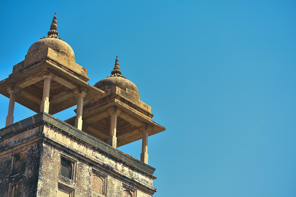 a tall tower with two domes on top of it