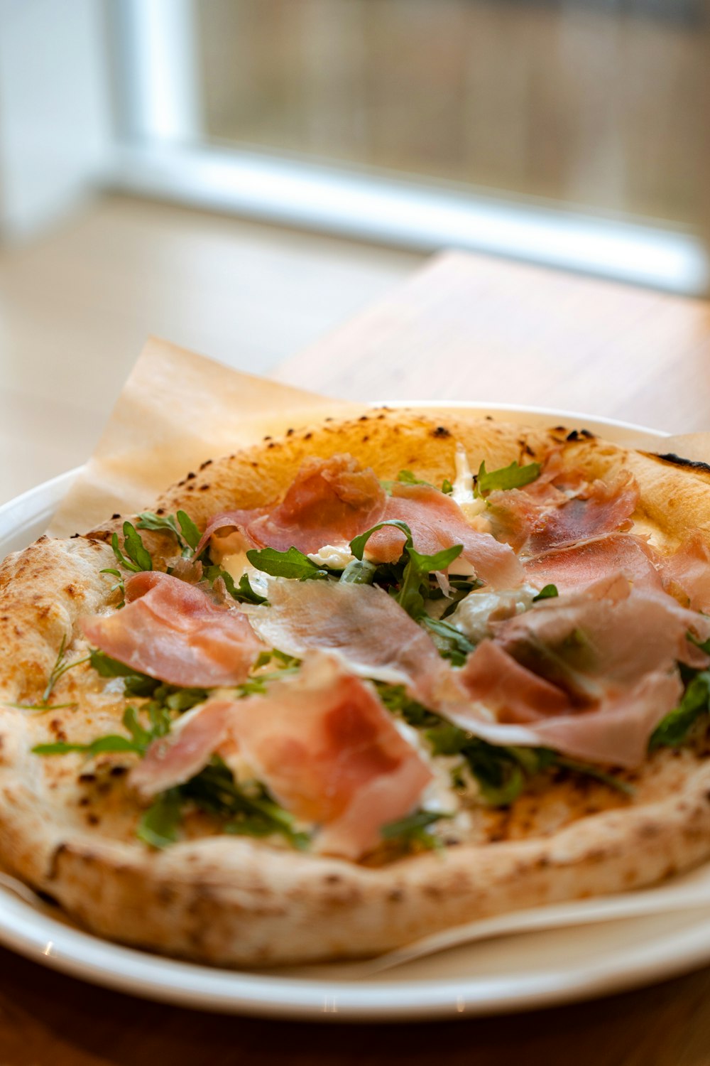 a small pizza on a plate on a table