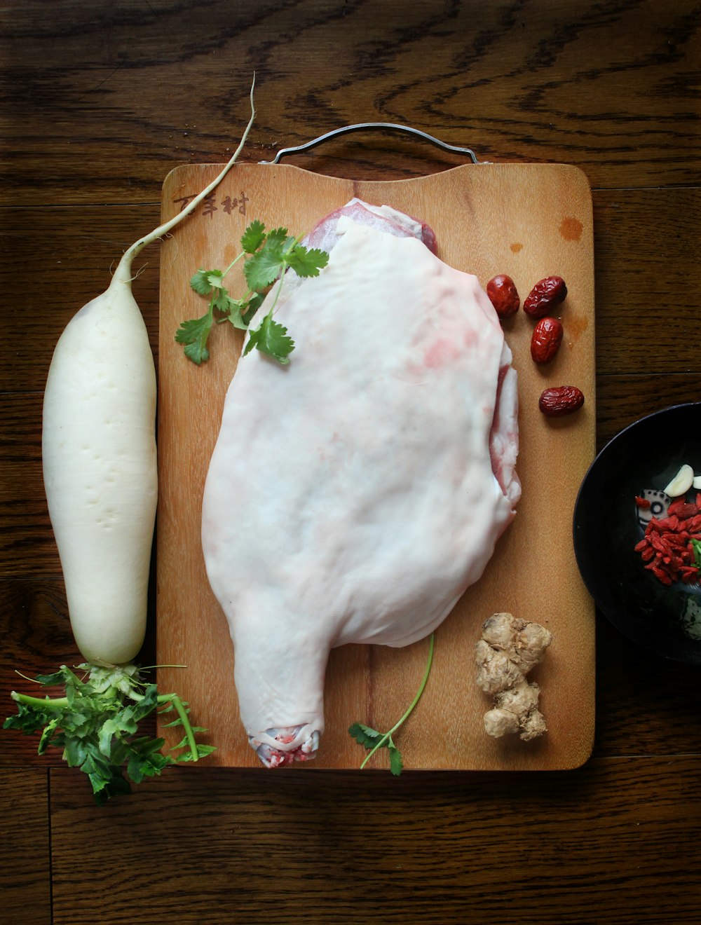 a large piece of meat sitting on top of a wooden cutting board