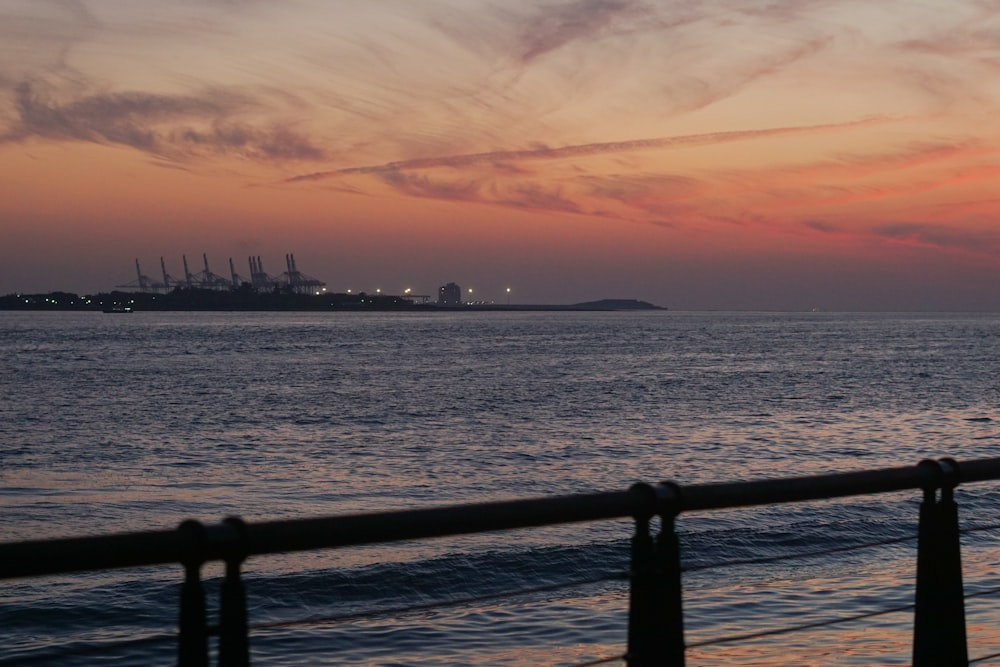 a view of the ocean at sunset from a pier