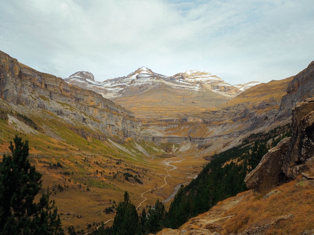 a view of a valley with mountains in the background