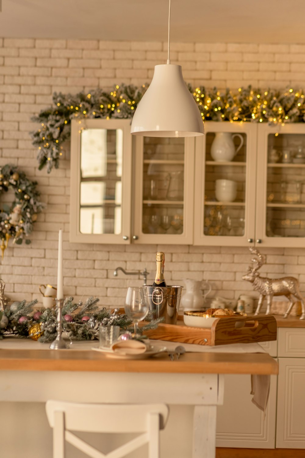 a kitchen with white cabinets and a wooden table