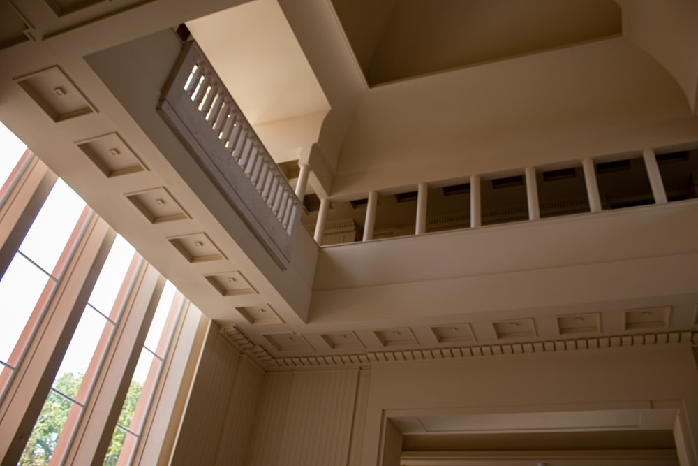 a room with a balcony and several windows