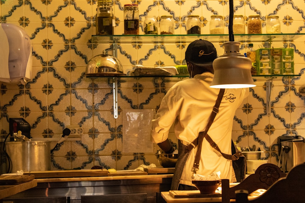 a man standing in a kitchen preparing food