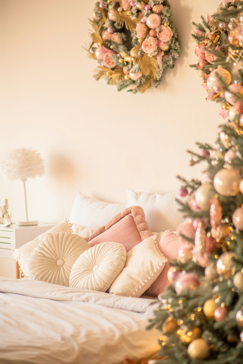 a decorated christmas tree in the corner of a bedroom