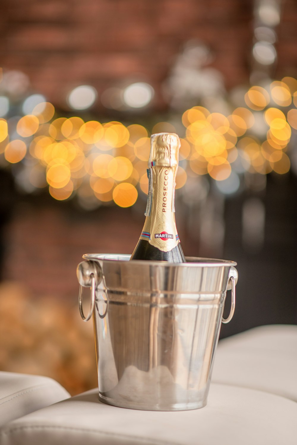 a bottle of champagne in a bucket on a couch