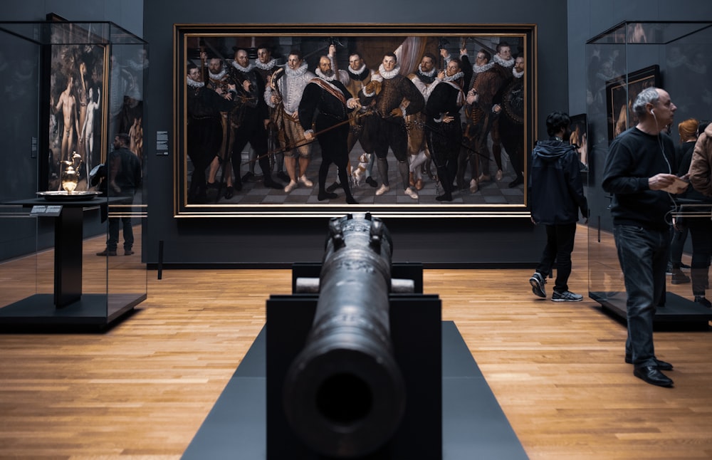 a group of people looking at a painting in a museum