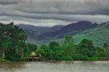 a body of water surrounded by trees and mountains