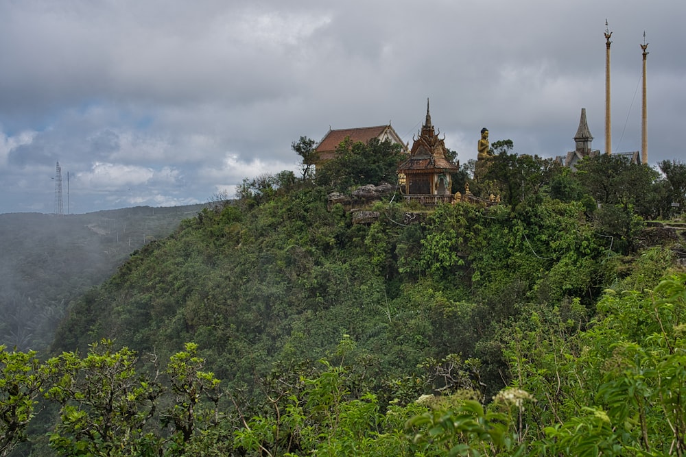 a large building on top of a lush green hillside