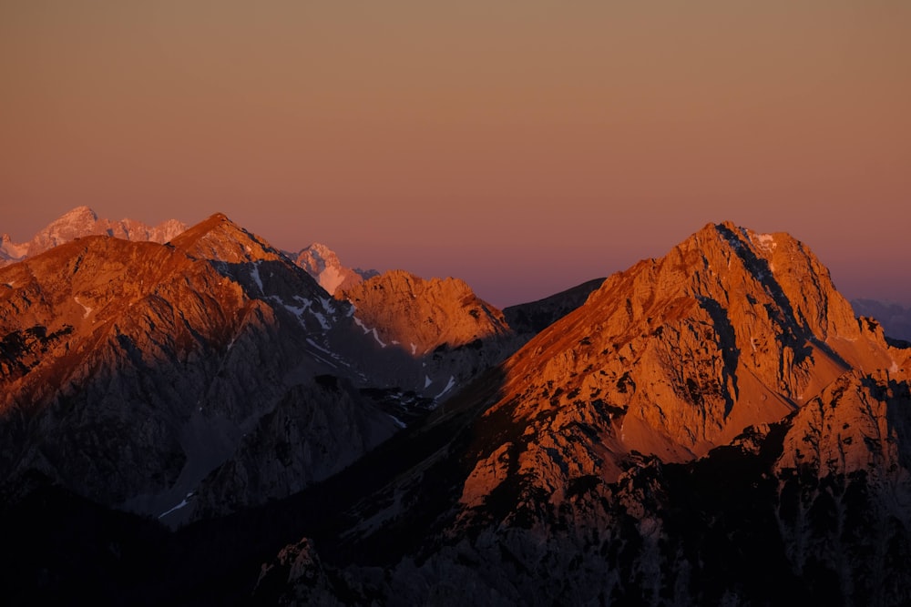 a view of the top of a mountain at sunset