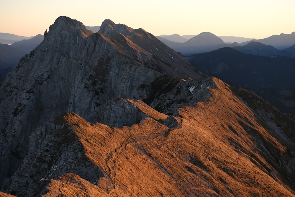 a view of the top of a mountain at sunset