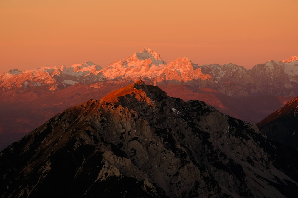 a view of the top of a mountain at sunset