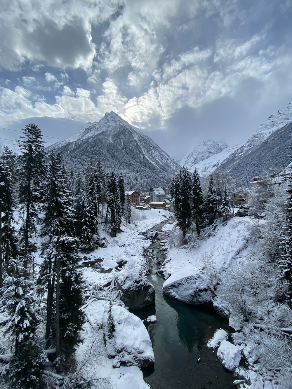 a river running through a snow covered forest