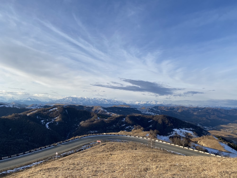 a scenic view of a road and mountains