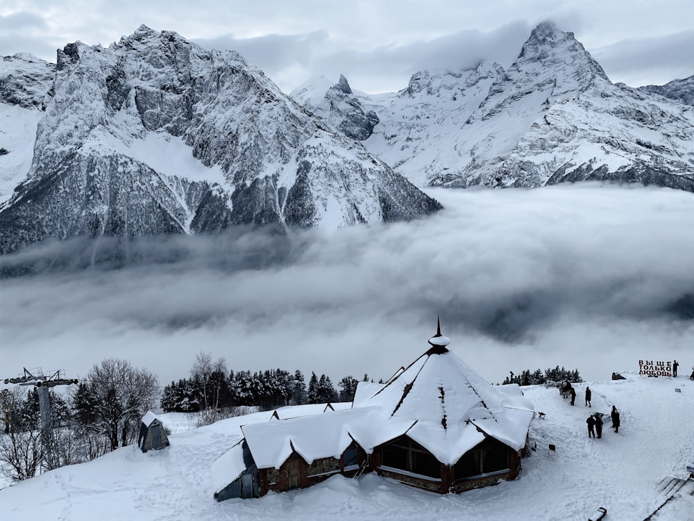 a group of people standing on top of a snow covered slope