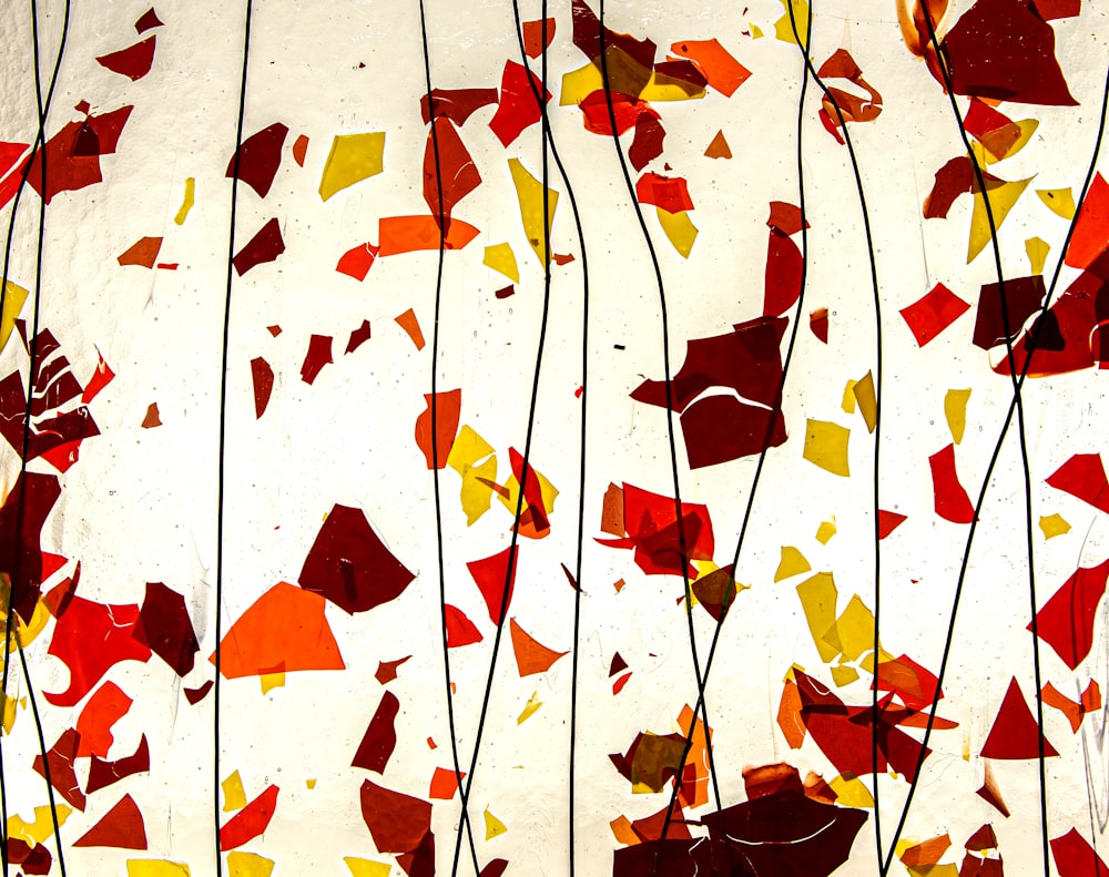 a painting of red, yellow, and orange leaves on a white background