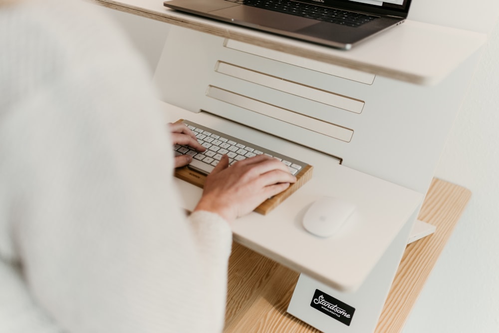 a person is typing on a computer keyboard