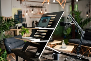 a laptop computer sitting on top of a wooden table