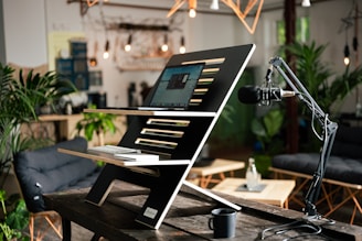 a laptop computer sitting on top of a wooden table