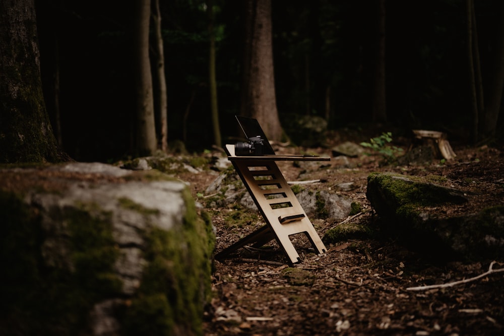 a wooden bench sitting in the middle of a forest