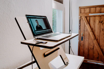 a laptop computer sitting on top of a wooden desk