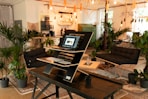 a laptop computer sitting on top of a wooden table