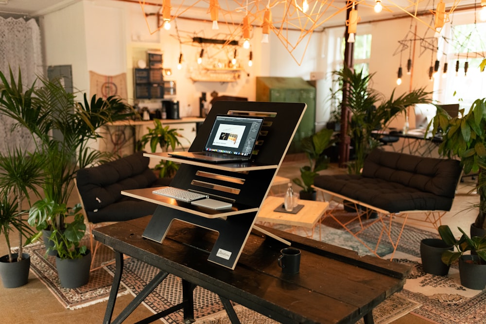 a laptop computer sitting on top of a wooden table