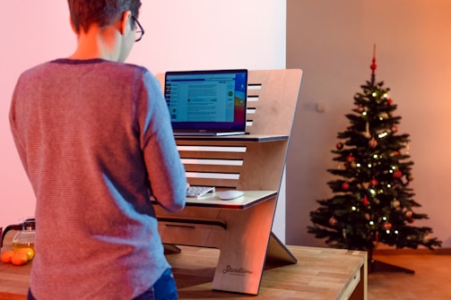 a person standing in front of a computer desk