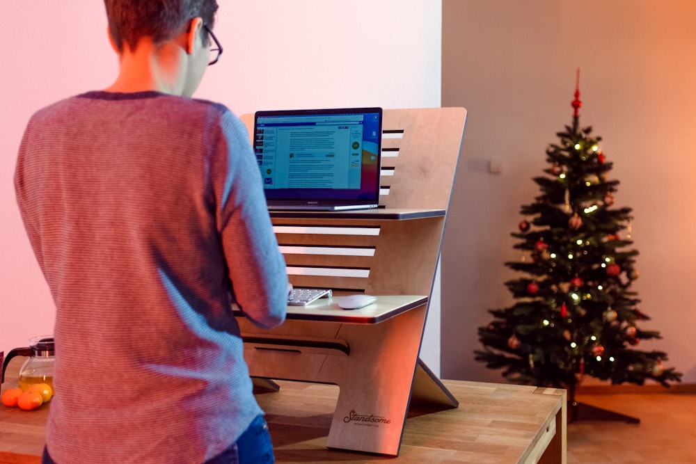 a person standing in front of a computer desk