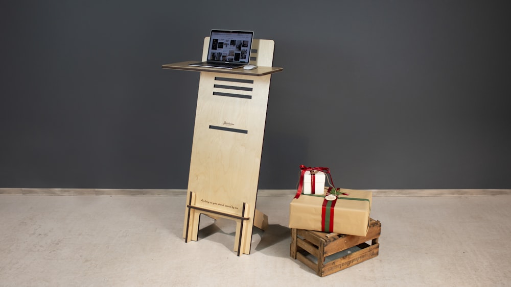 a wooden tower with a laptop on top of it