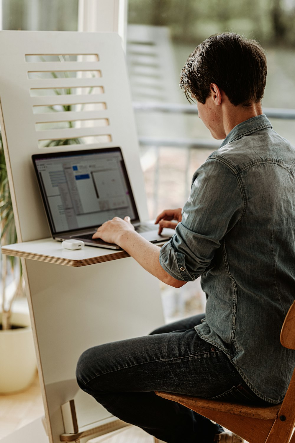Before: person hunched over a laptop at a standing desk with poor posture