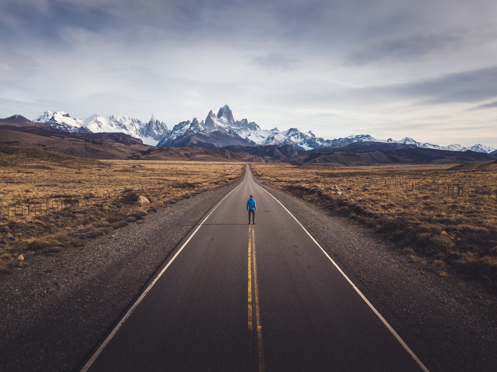 a person walking down the middle of a road