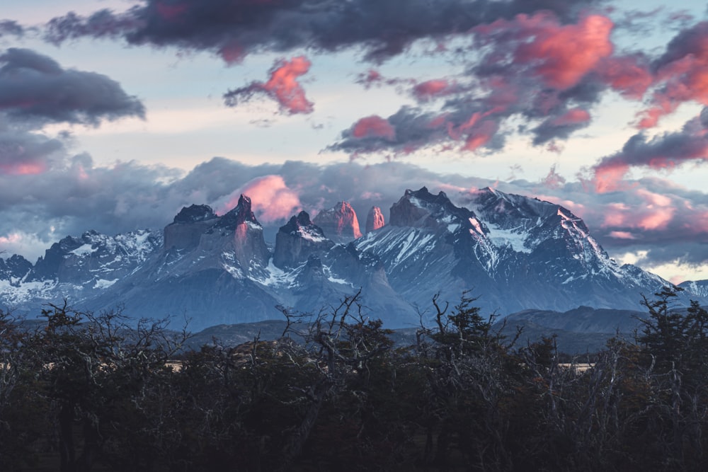 a view of a mountain range with clouds in the sky