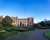 a large building surrounded by hedges and trees
