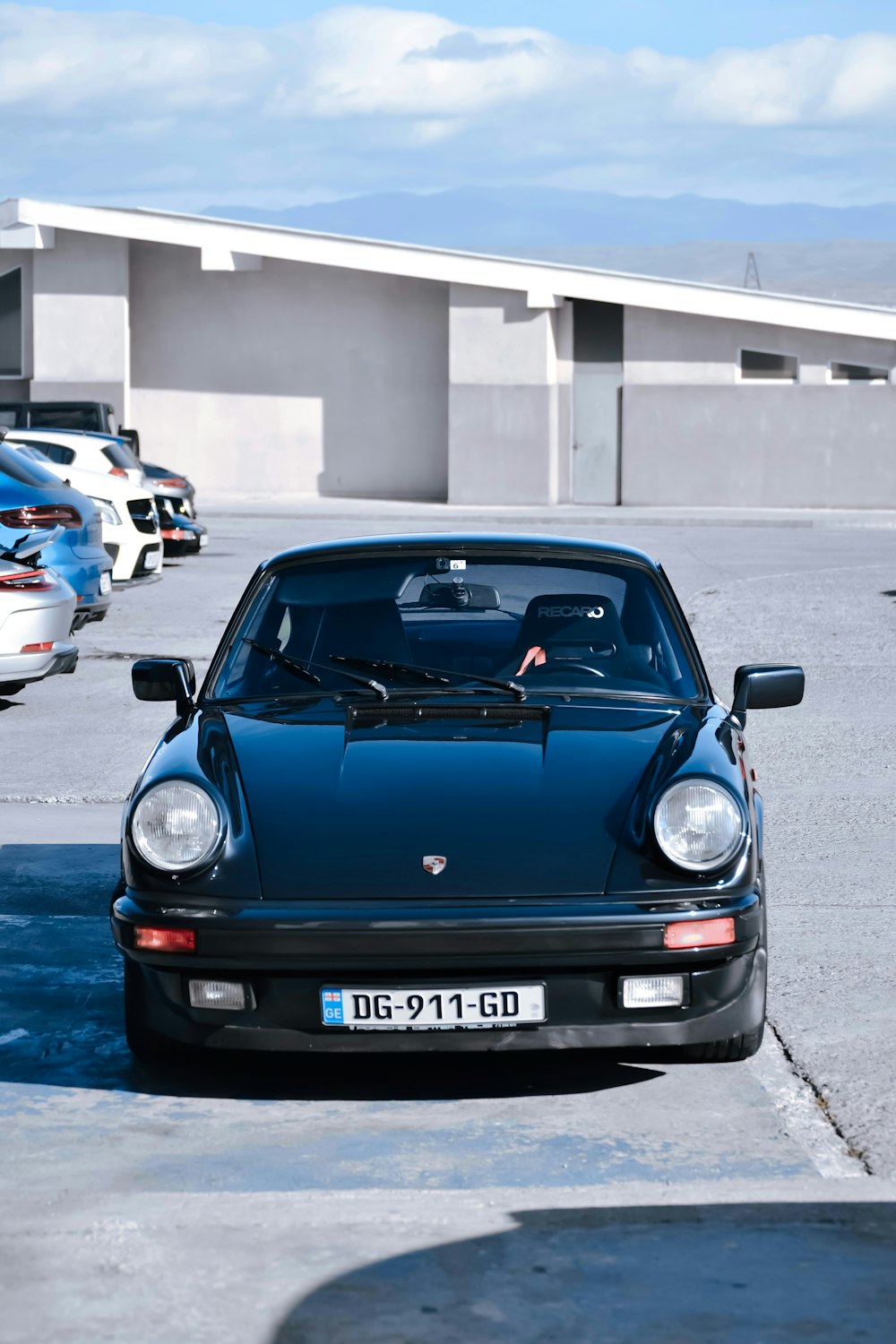 a blue sports car parked in a parking lot