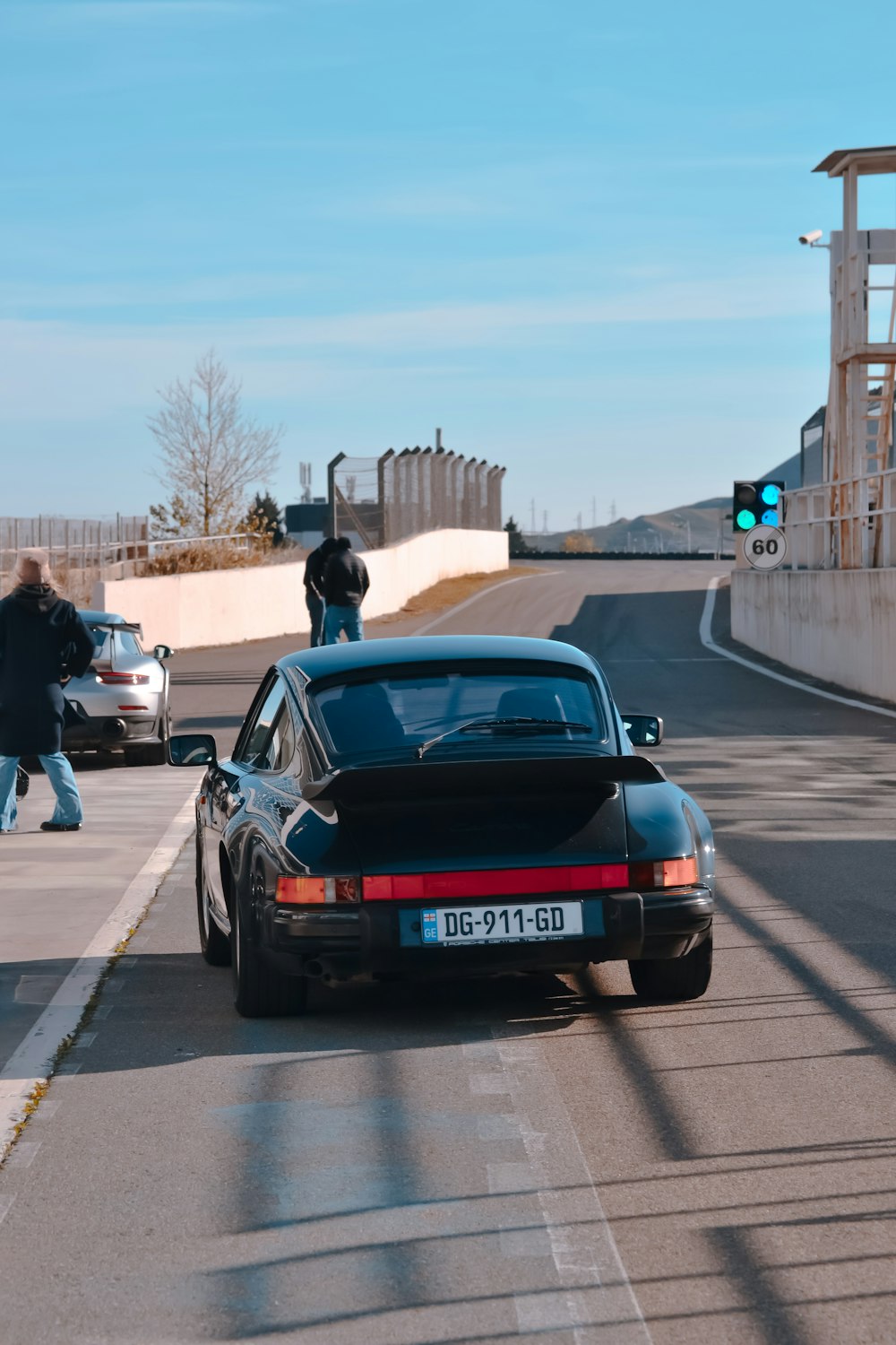 a black porsche parked on the side of the road